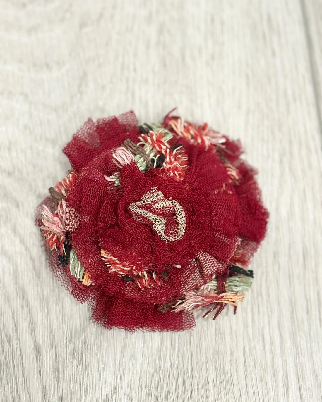 Chanel Camellia brooch in beige pink and brown.