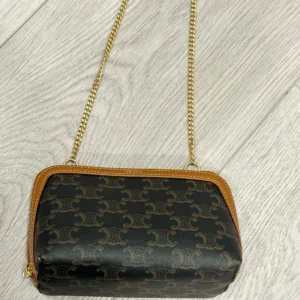 Celine clutch with chain in triumph canvas